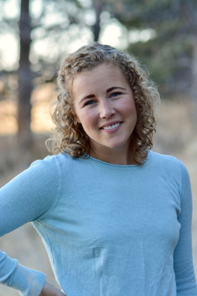 Hannah Wurster, PhD, licensed marriage and family therapist, outdoors, smiling, wearing a light blue top.