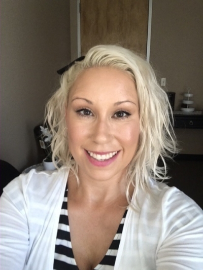 Nataeah Barron, licensed marriage and family therapist, licensed addiction counselor, smiling, wearing a black and white striped shirt under a white shirt