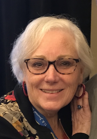 Arleen Brown, licensed clinical social worker, certified addiction counselor, smiling, with short hair and wearing glasses.