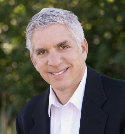 Jonathan Zalesne, licensed professional counselor, at Colorado Center for Couples and Families, smiling, wearing a white shirt and dark jacket