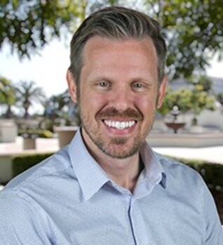 Gregory Seibert, PhD, licensed marriage and family therapist in Fort Collins, Colo. Smiling, wearing a light blue shirt