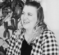 Whitney Walkenhorst, licensed clinical social worker, licensed addiction counselor, smiling, wearing a checked shirt