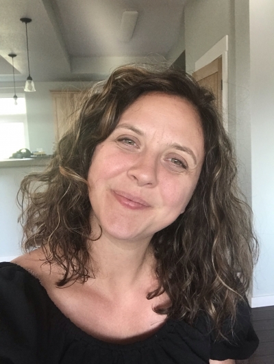 Jessica Brien, licensed professional counselor. She is smiling, and has green eyes and light brown, curly, shoulder-length hair.