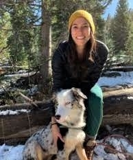 Amanda Messier, licensed professional counselor, and her dog outdoors in winter