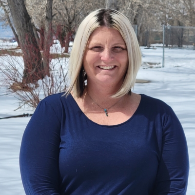 Tasha Steinbach, licensed clinical social worker, certified addiction specialist, smiling standing outdoors in the sunshine