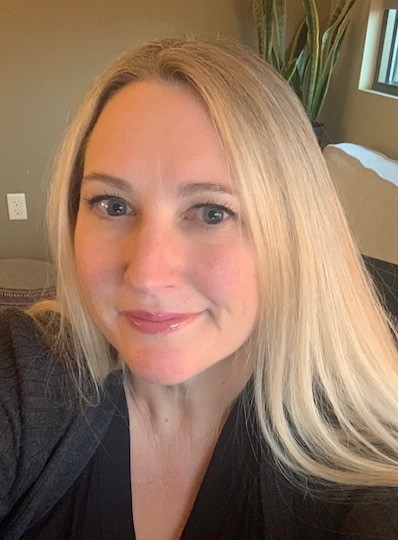 Khristie Kendall, licensed professional counselor, smiling with long blonde hair, in her office