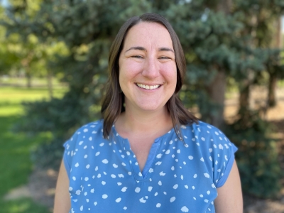 Jen Head, licensed clinical social worker, standing outdoors, smiling, wearing a blue shirt with white designs