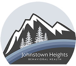 Logo for Johnstown Heights Behavioral Health, with drawing of snowcapped mountains, with pine trees.