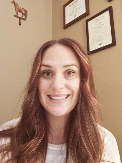 Liza Slavin, licensed clinical social worker, sitting in an office, smiling
