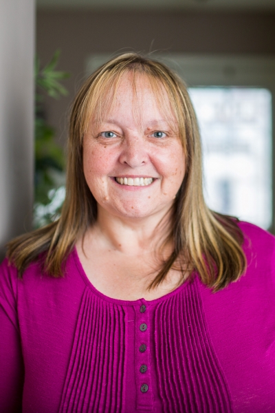 Jennifer Orr, licensed professional counselor, smiling, wearing a fuchsia top