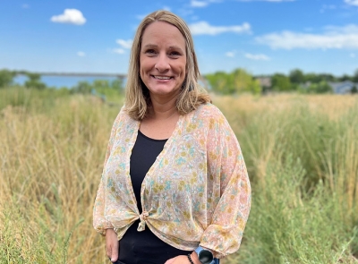 Chanda Elkins, social work candidate, white female standing outdoors in a field of grass