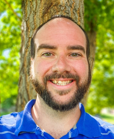 Aaron Hill, licensed clinical social worker, licensed addiction counselor, outdoors, smiling, near a tree