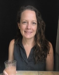 Kelly Shea, licensed clinical social worker, smiling, sitting at a table