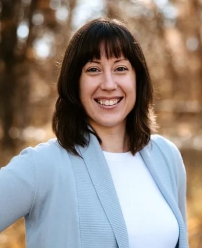 Erin Pauling, licensed clinical social worker, smiling wearing a white top and a light blue sweater