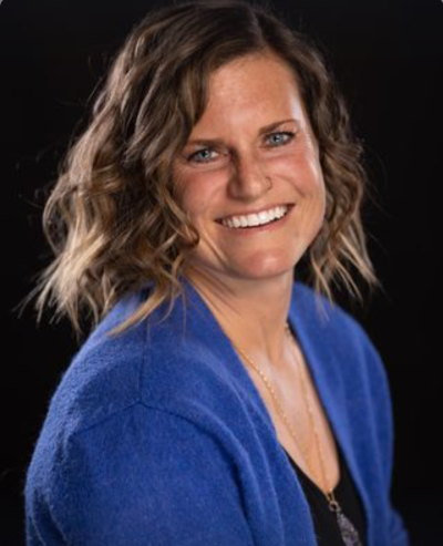 Jeanette Jennings, licensed professional counselor, smiling, wearing a black top and blue sweater