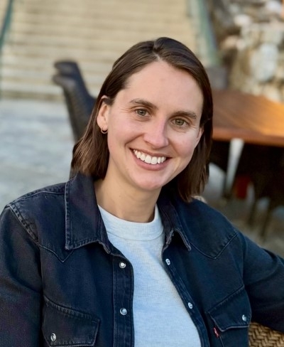 Anna Hanson, licensed clinical social worker, smiling, wearing a white T-shirt and denim shirt