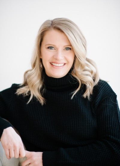 Kelly Sonnenfeld, licensed psychologist, with shoulder-length blonde hair, wearing a black turtleneck sweater