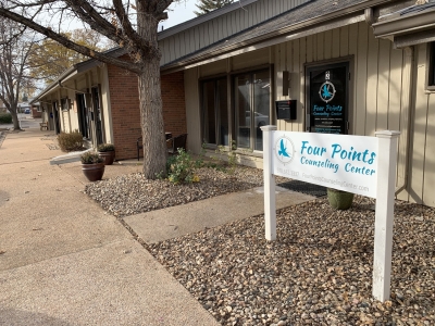 View of Fort Collins building from parking lot, with sign that says Four Points Counseling Center