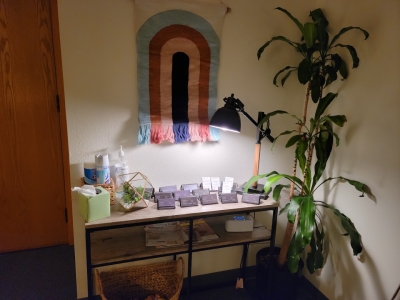 Welcome area with potted plant, colorful wall decoration