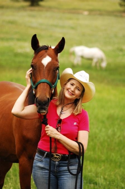 Suzanne and her horse, Harmony, out standing in a field
