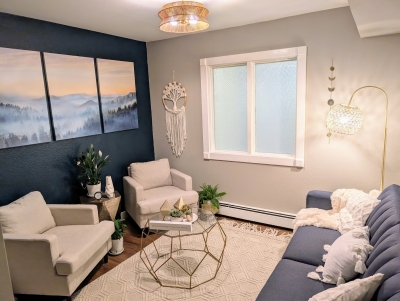 Another view of the office space, showing window, chairs, and sofa.