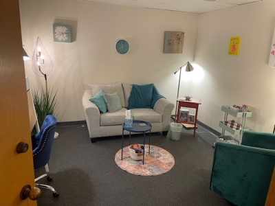 Office with sofa and comfortable chair, floor lamps