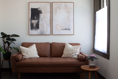 Office with sofa and pillows, a plant, and window
