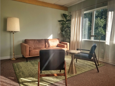Therapy office with sofa, two chairs and a window