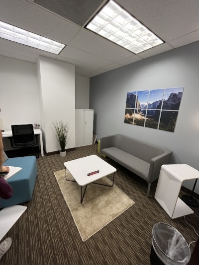 Momentum Office in Denver, with sofa and chairs, a desk, and a coffee table.