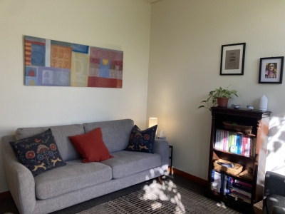 Therapy office with couch and bookcase