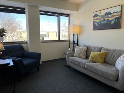 Office with sofa, chair, and a view out the window