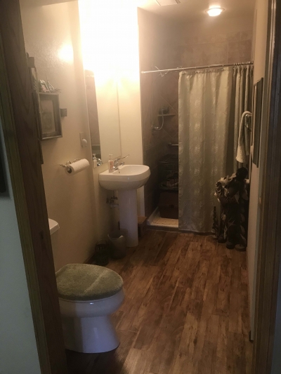 Restroom, with grab bars at the toilet. An extra-wide doorway provides access for walkers or wheelchairs. 