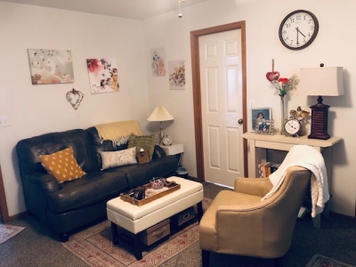 View of office with sofa and comfortable chair