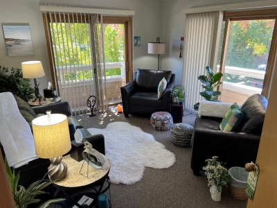 My counseling office, with large windows, comfortable chairs, and sofa