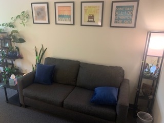 Office, with a sofa, floor lamp, and plants