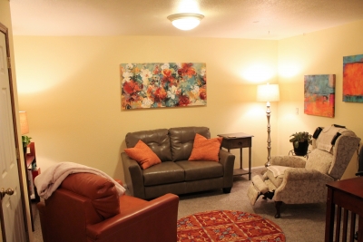 Well-lit office with loveseat and 2 chairs 