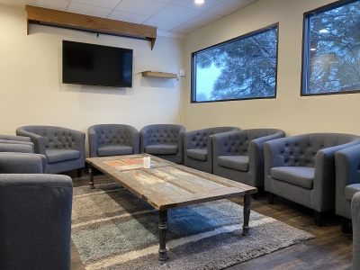 ReStory Counseling group room with comfortable chairs around a coffee table in the center