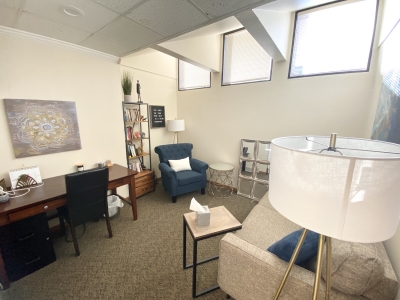 ReStory Counseling office with windows, chairs and desk.